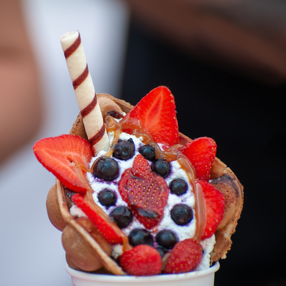 Delicious sweet bubble waffle on table